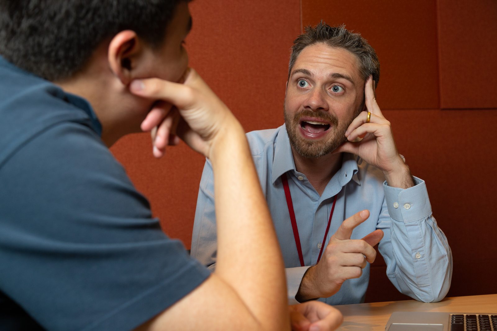 A staff member in a one-to-one conversation with a student